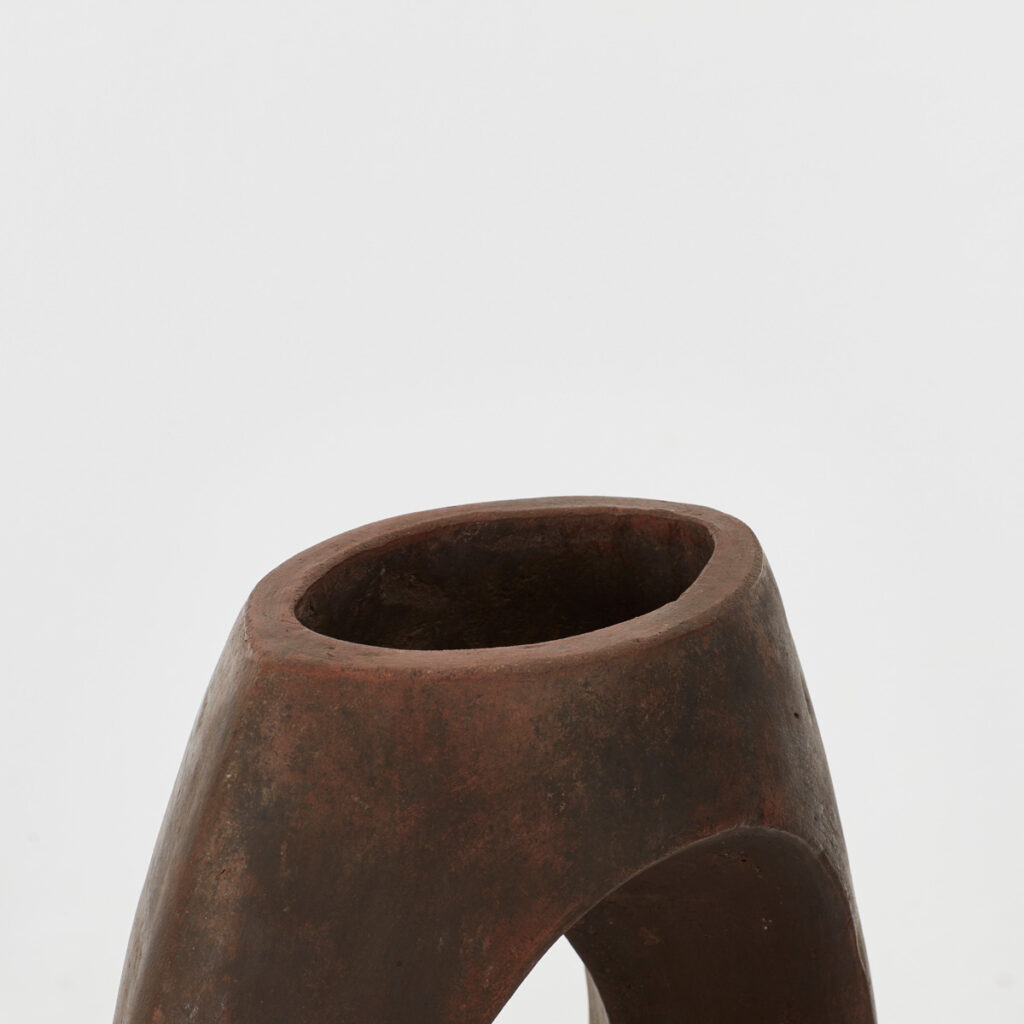 Pierced studio pottery vase in terracotta