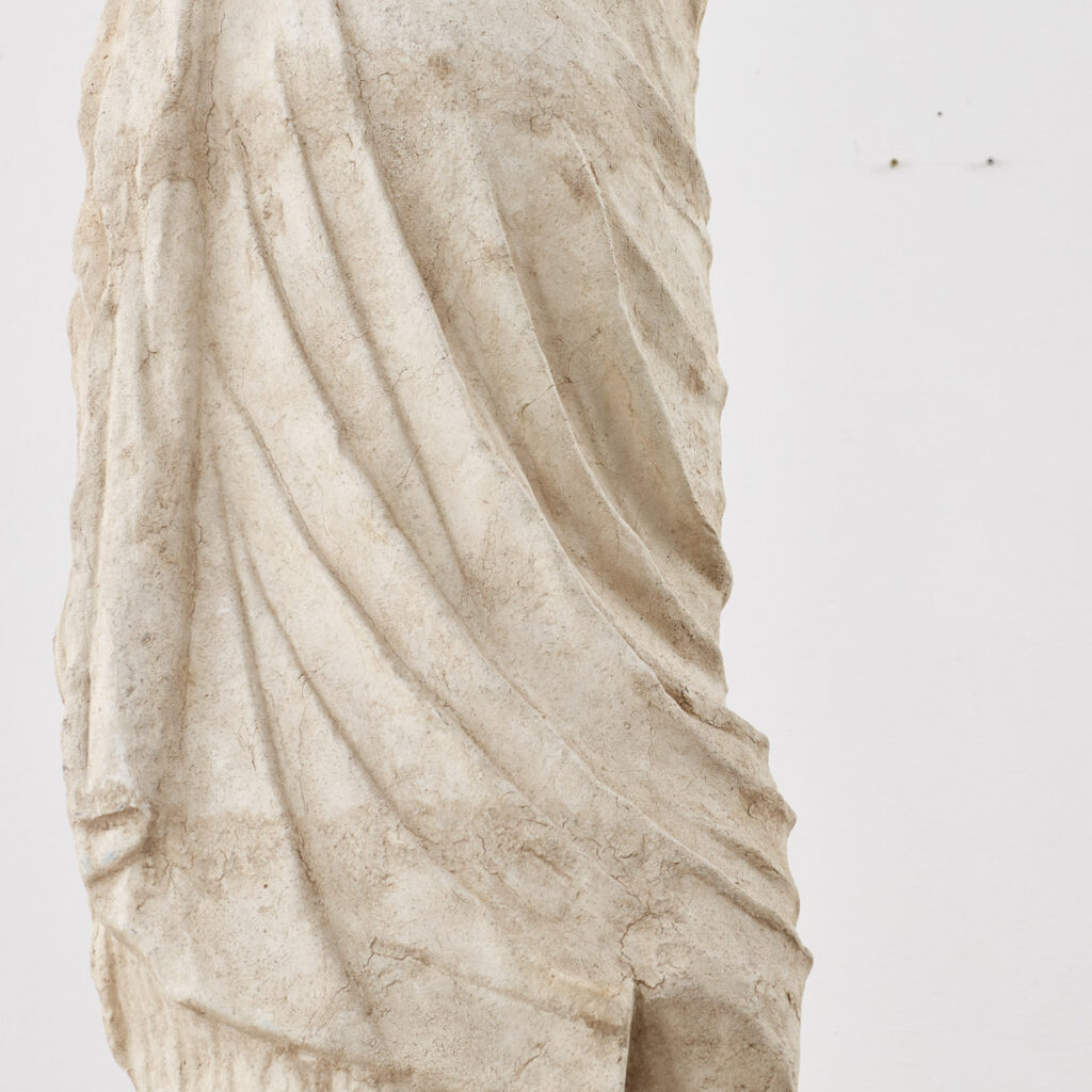A Neoclassical statue of figure on plinth