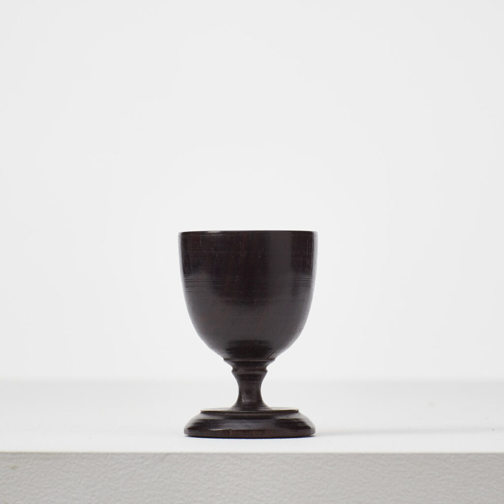 Pair of antique ebonised egg cups