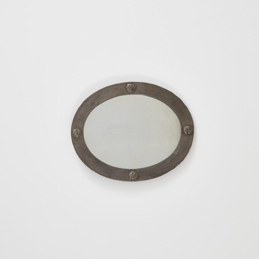 Arts & Crafts oval mirror in hammered pewter