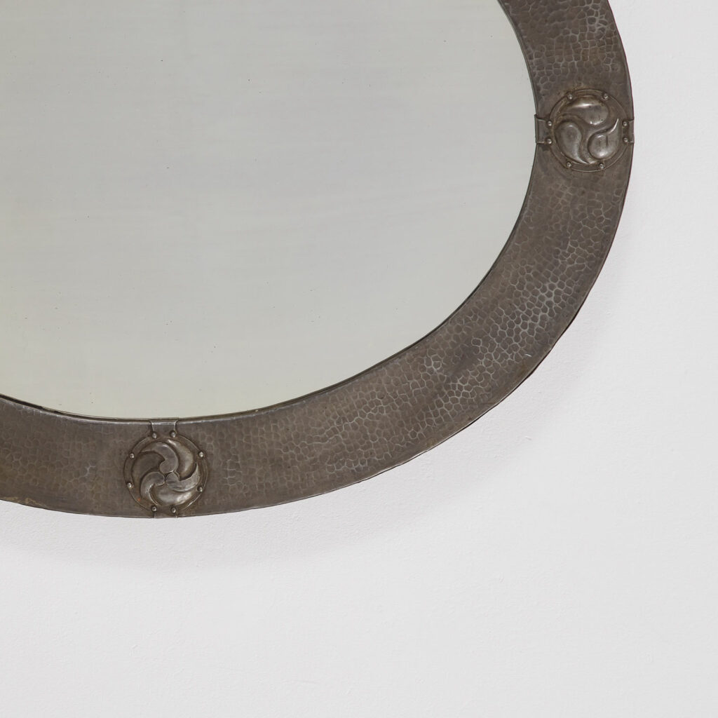 Arts & Crafts oval mirror in hammered pewter