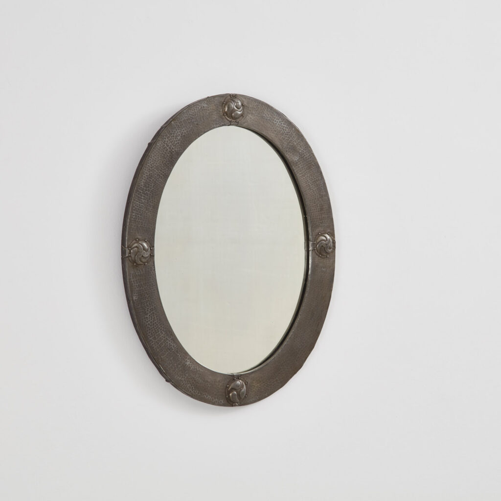 Arts & Crafts oval mirror in hammered pewter